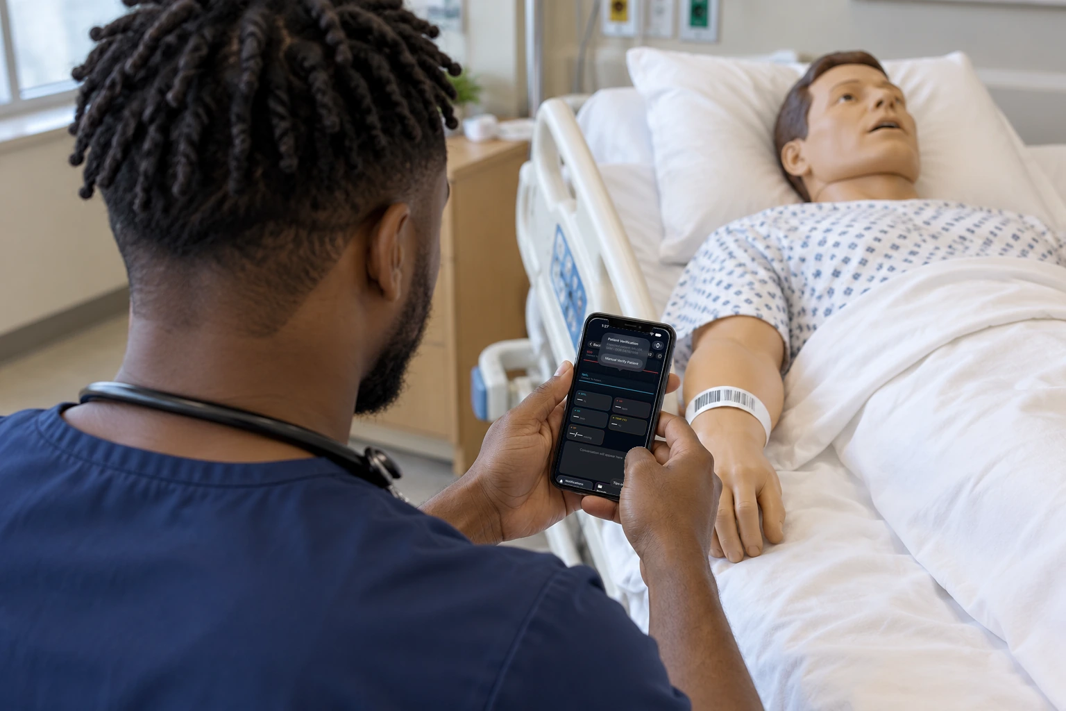 A student scans a manikin's wristband. The phone asks how the patient was verified, and the badge still says not verified.