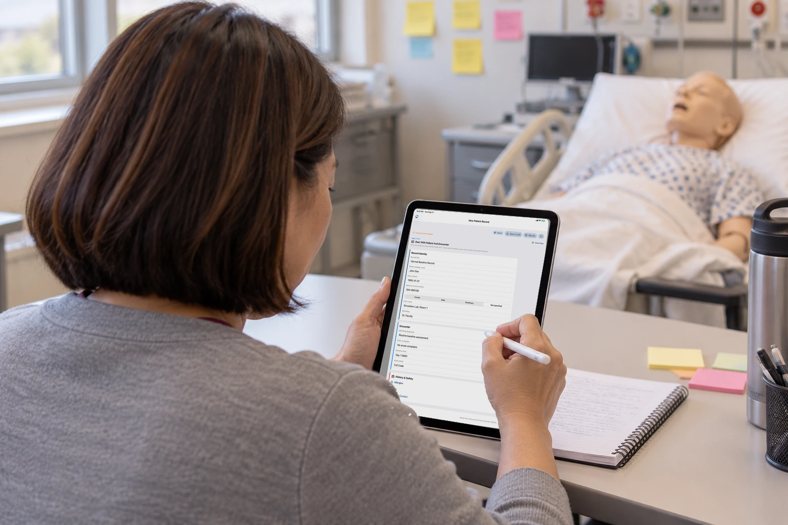 A faculty member holds an iPad on the first guided step, the patient.